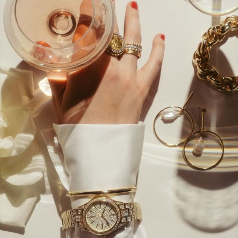 About us Hand with luxury gold jewelry and watch